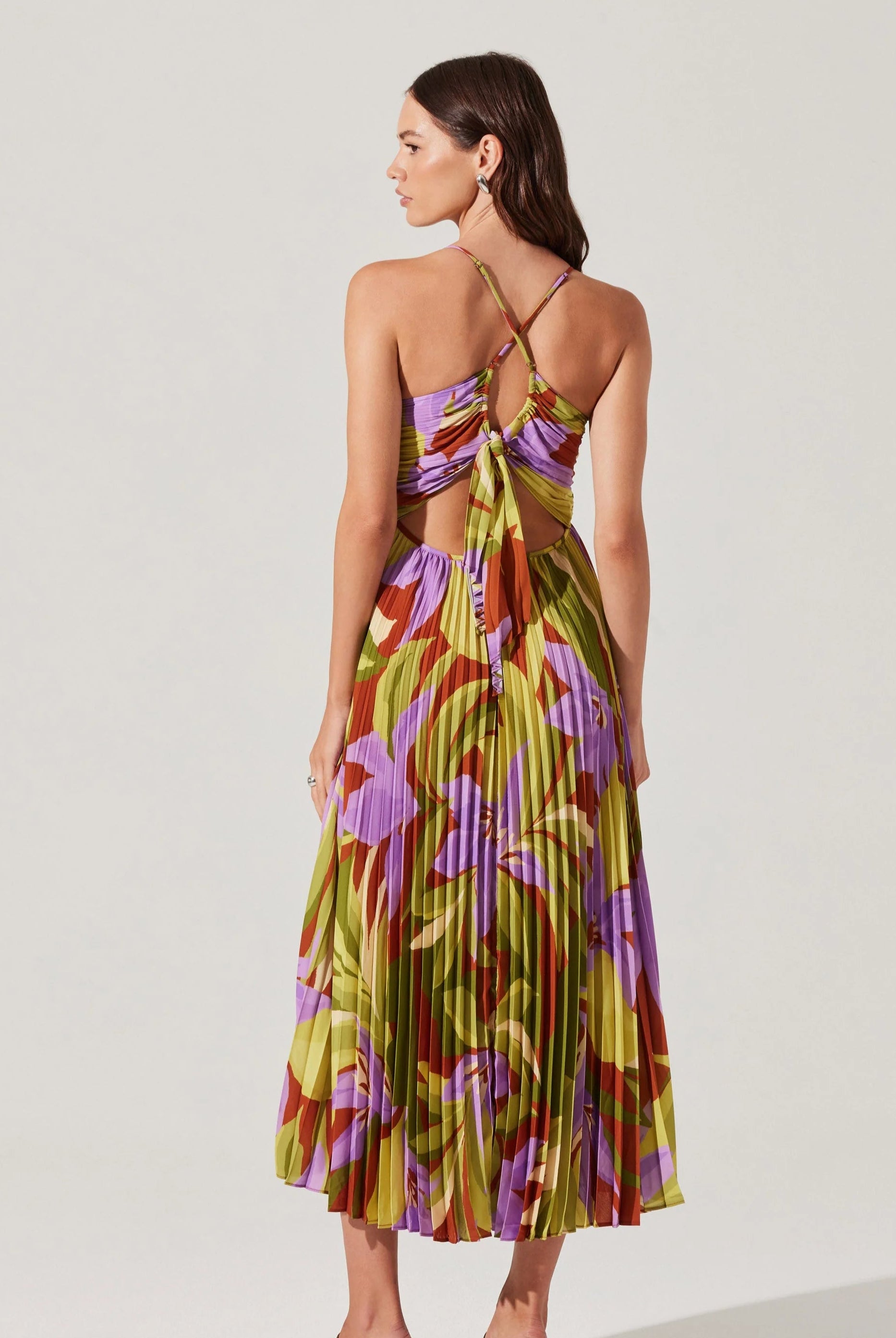 Woman wearing a colorful floral dress on a white background