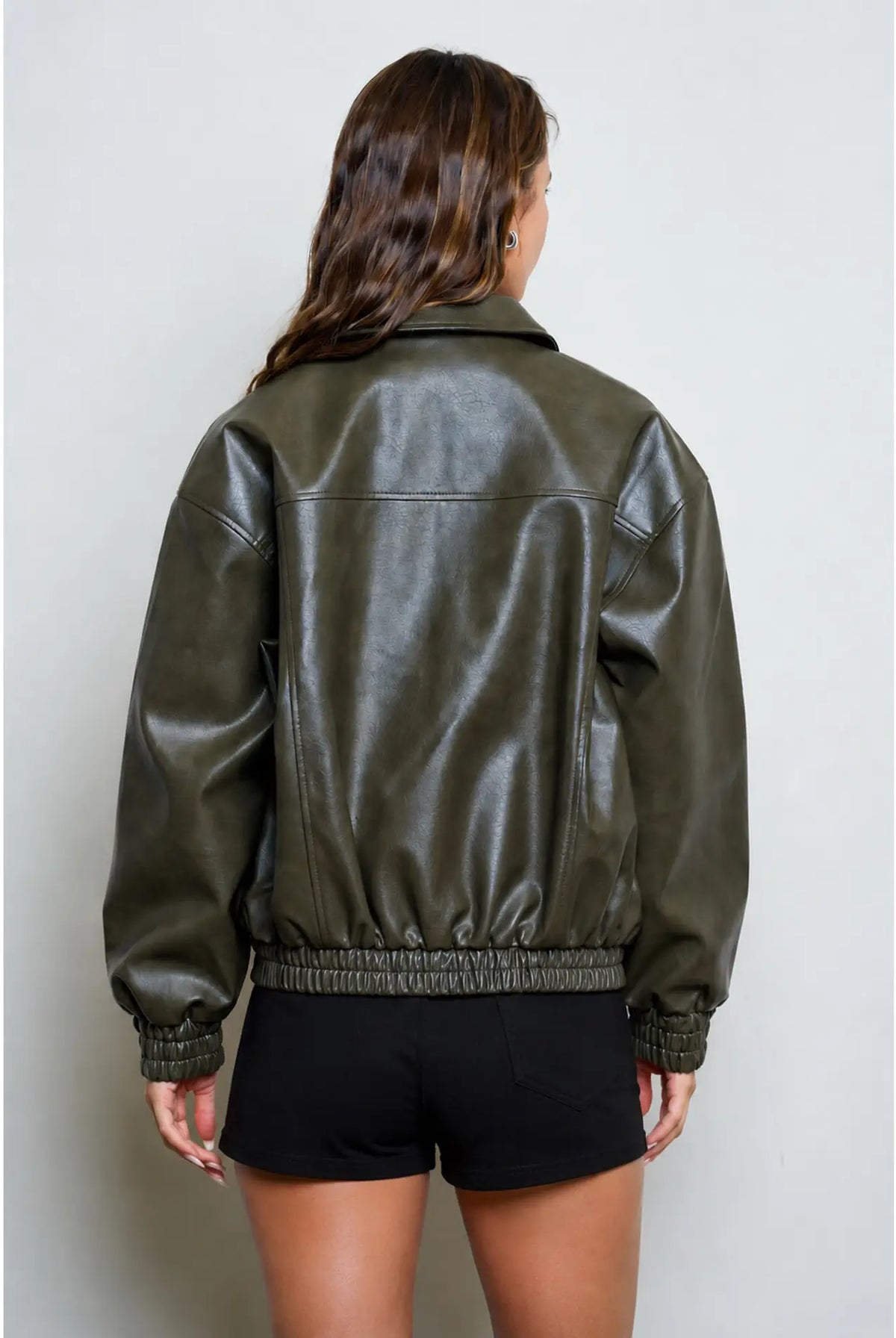 Women’s olive collared bomber jacket featuring a relaxed fit, zip-front closure, long sleeves, and gathered elastic cuffs and hem.