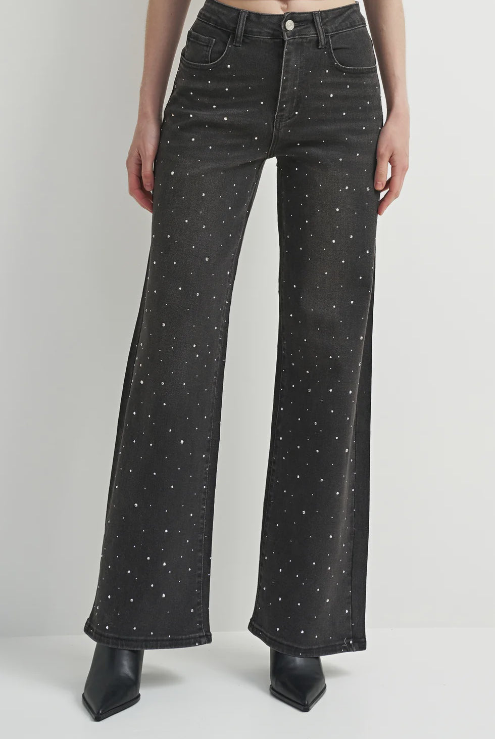 Washed black denim jeans with a flattering leg and rhinestone detailing, adding a subtle western-inspired touch.