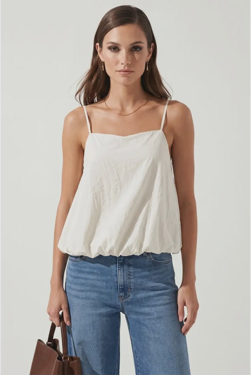 Off white bubble cami tank featuring a square neckline, adjustable spaghetti straps, a relaxed flowy silhouette, and a gathered bubble hem