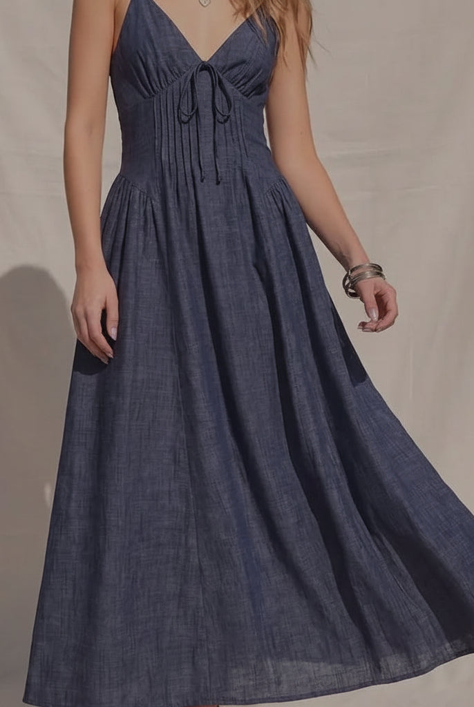 Women's denim fit-and-flare midi dress with a V-neckline, corset waist detailing, adjustable straps, a smocked back, and a flattering feminine silhouette.