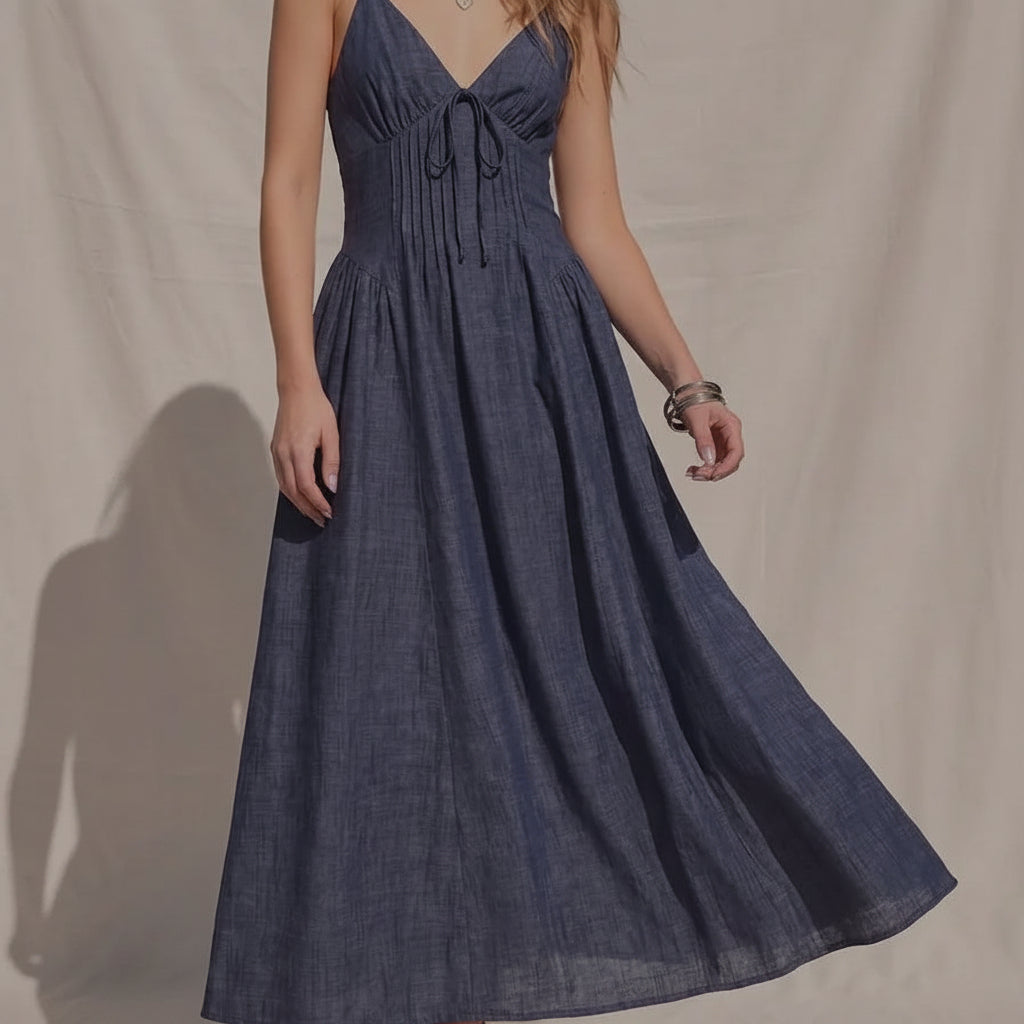 Women's denim fit-and-flare midi dress with a V-neckline, corset waist detailing, adjustable straps, a smocked back, and a flattering feminine silhouette.