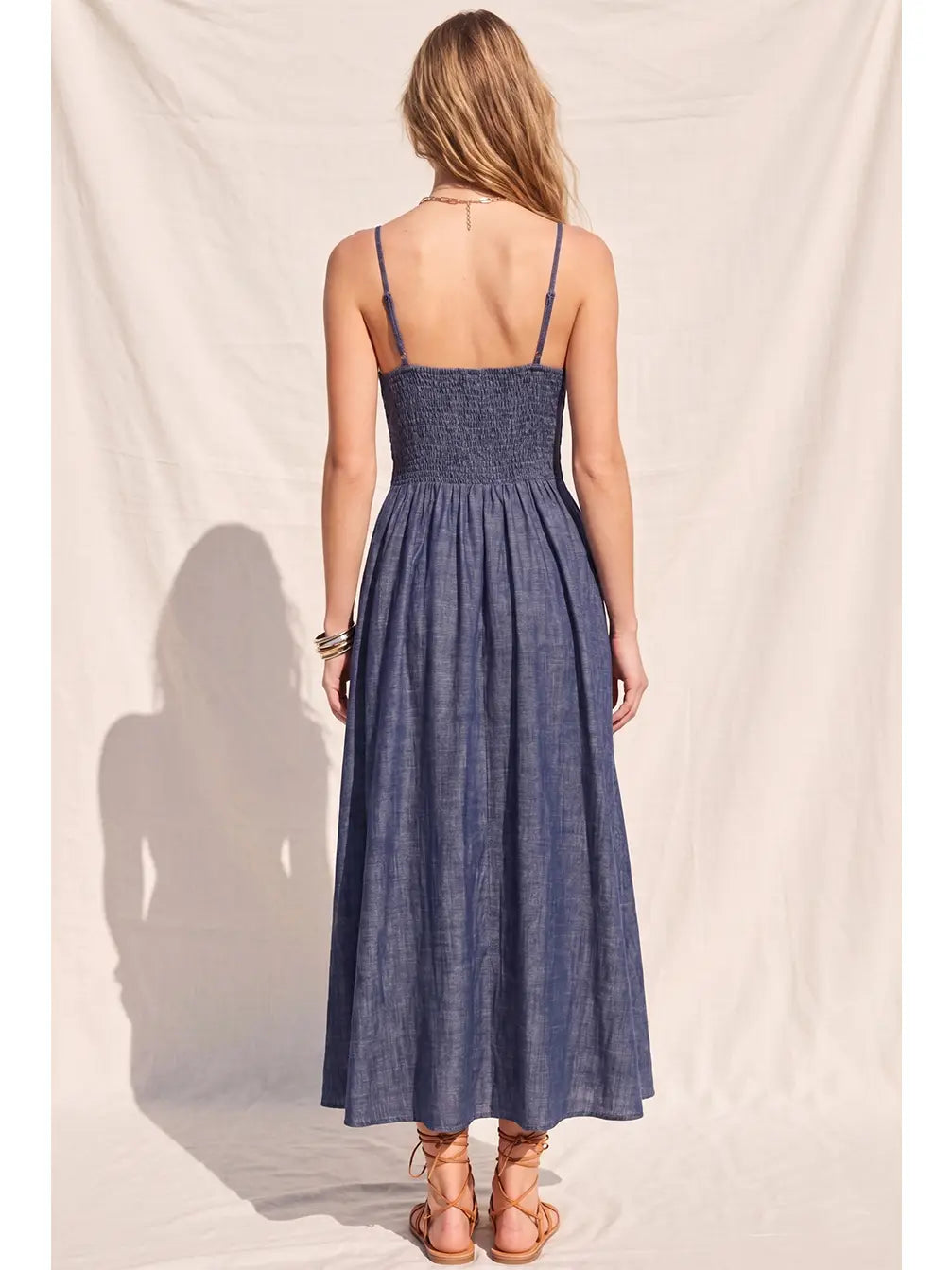 Women's denim fit-and-flare midi dress with a V-neckline, corset waist detailing, adjustable straps, a smocked back, and a flattering feminine silhouette.
