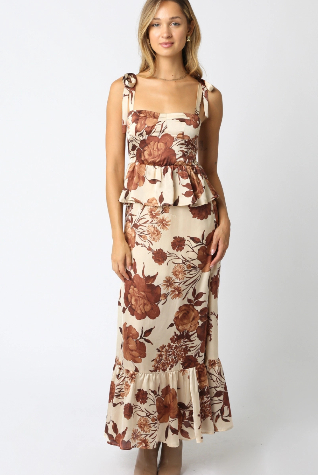 Woman wearing a floral dress on a white background. Shop at Lee & Me Boutique