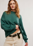A girl wearing an oversized turtleneck with beige pants