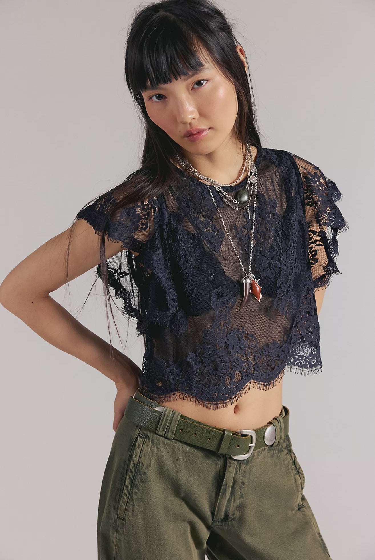 Woman wearing a black sheer lace top