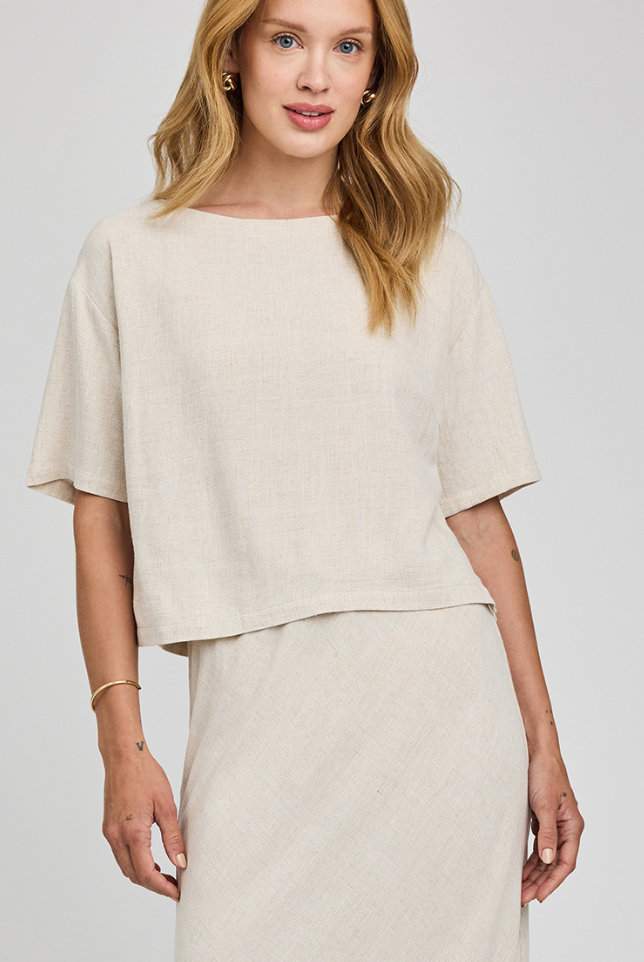 Woman wearing a beige outfit on a white background
