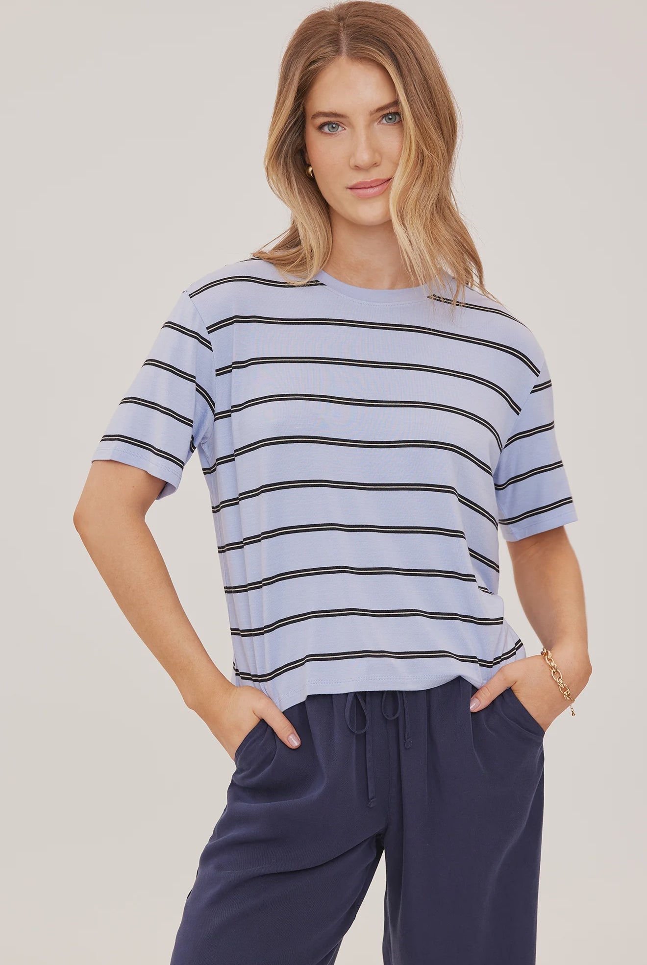 Women's relaxed oversized crewneck t-shirt featuring sky blue and white stripes, crafted from soft jersey knit with short sleeves and a comfortable oversized silhouette.