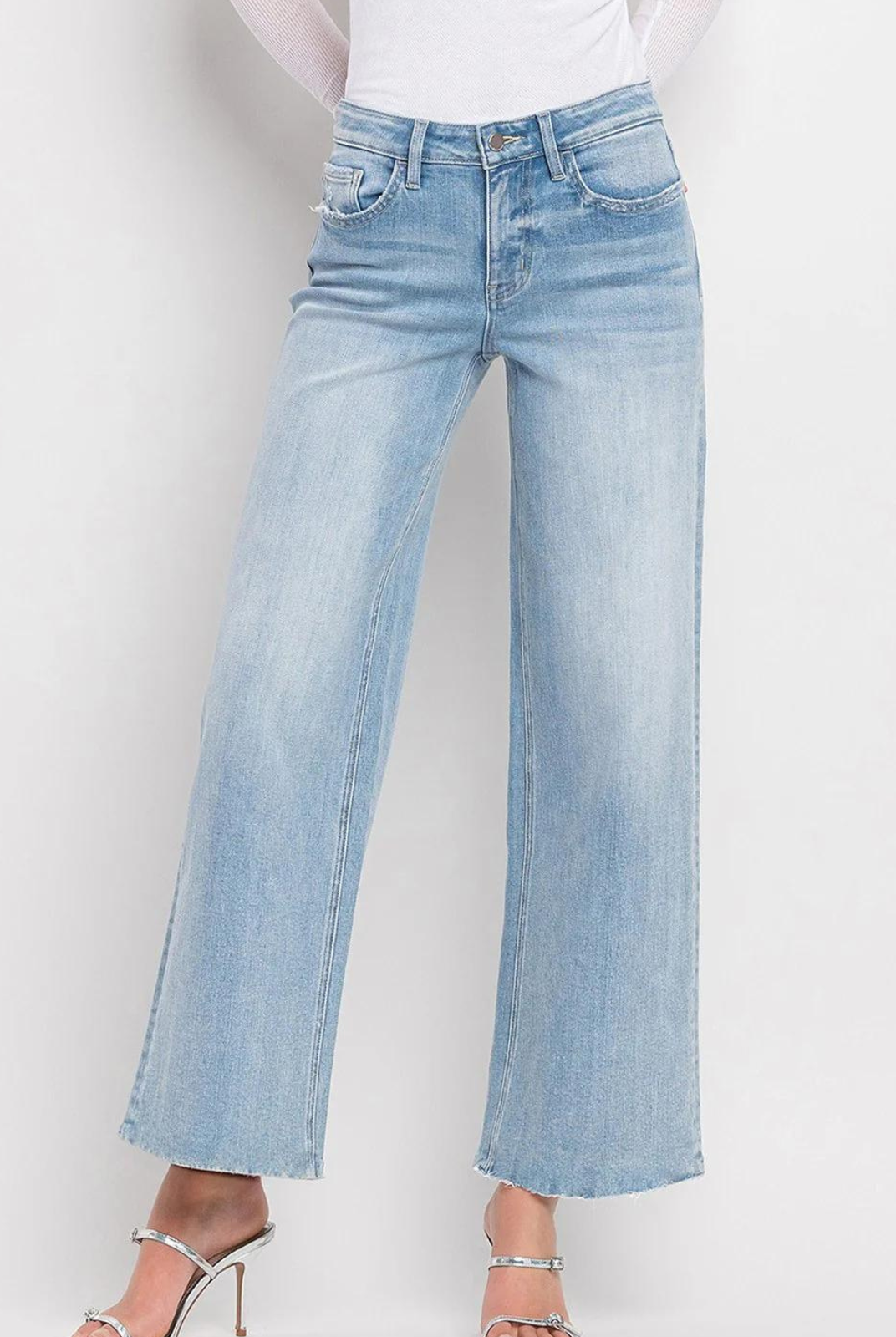 Vervet By Flying Monkey High Rise Wide Leg Jeans -Ben Rinnes. Crafted from comfort stretch denim, these jeans feature a high rise waist that flatters and a raw hem for a trendy touch. The full length and wide leg design offer both comfort and style, making these the perfect addition to any wardrobe.