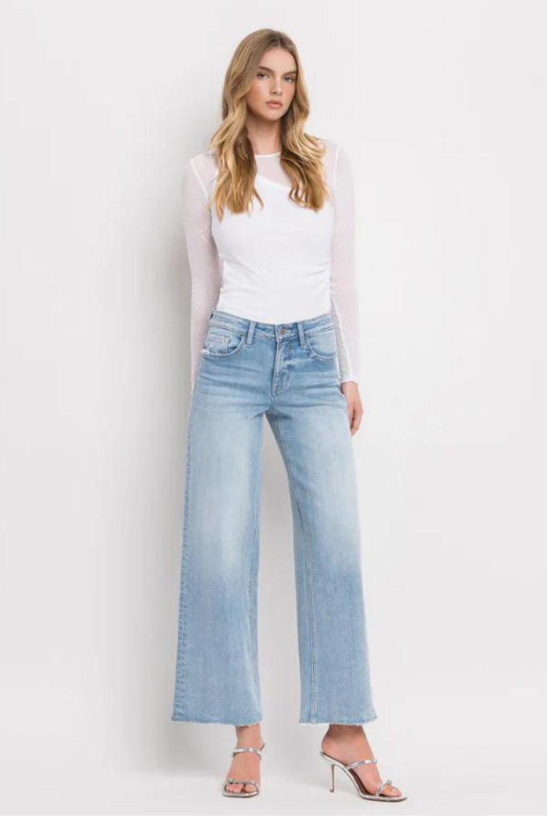 Vervet By Flying Monkey High Rise Wide Leg Jeans -Ben Rinnes. Crafted from comfort stretch denim, these jeans feature a high rise waist that flatters and a raw hem for a trendy touch. The full length and wide leg design offer both comfort and style, making these the perfect addition to any wardrobe.