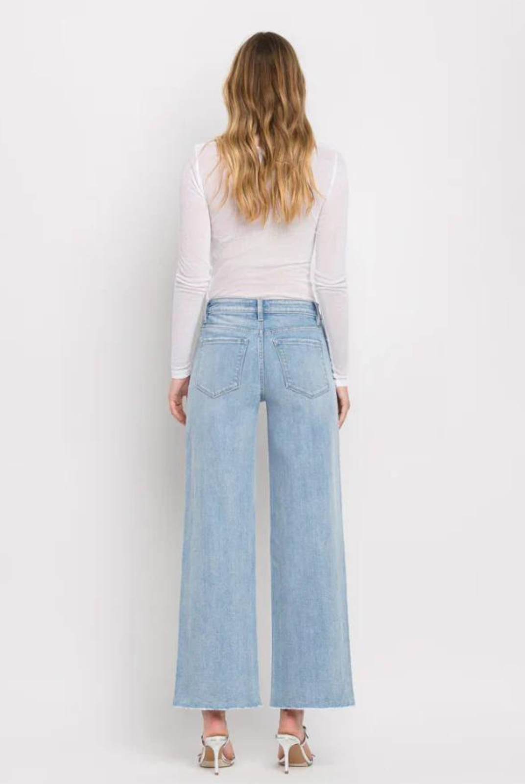 Vervet By Flying Monkey High Rise Wide Leg Jeans -Ben Rinnes. Crafted from comfort stretch denim, these jeans feature a high rise waist that flatters and a raw hem for a trendy touch. The full length and wide leg design offer both comfort and style, making these the perfect addition to any wardrobe.