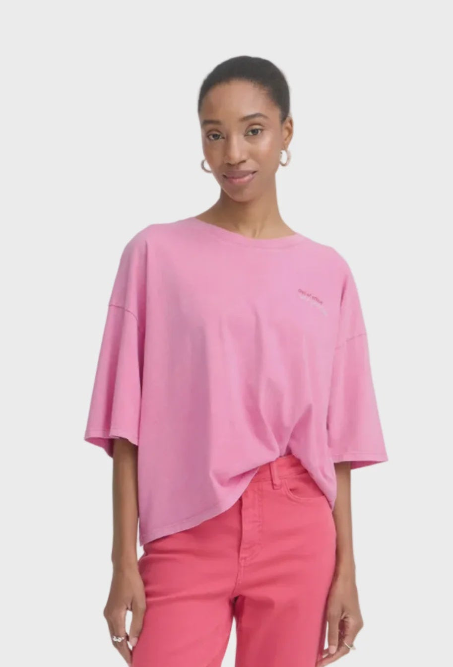 Woman wearing a pink top and pants on a white background