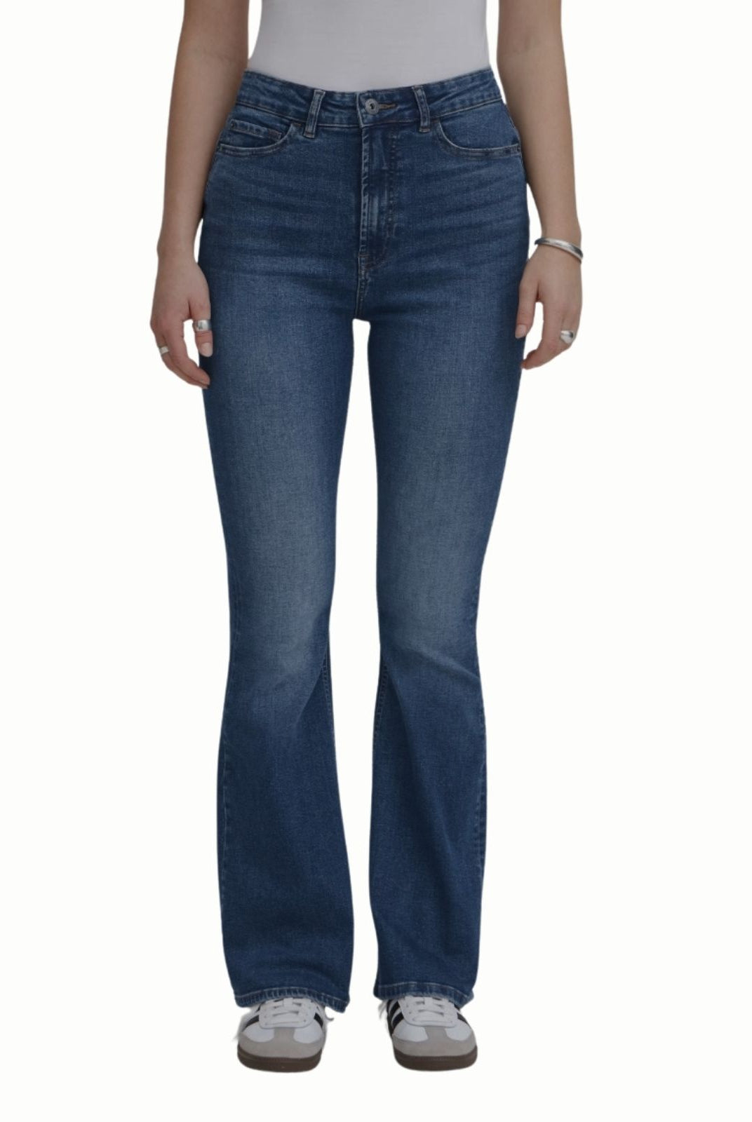 Blue jeans worn by a person on a white background