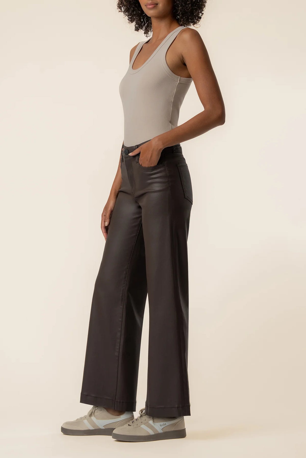 Coated wide-leg jeans featuring a sleek finish, Fab Ab front pockets, ankle-grazing length, and raw wide hems for a modern silhouette.