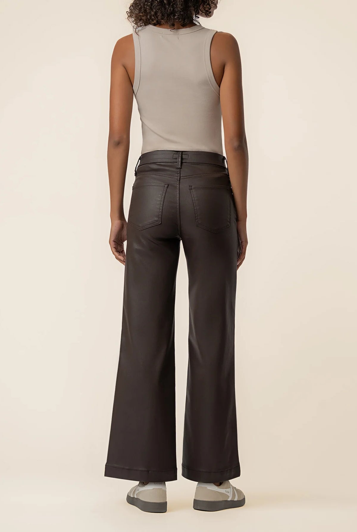 Coated wide-leg jeans featuring a sleek finish, Fab Ab front pockets, ankle-grazing length, and raw wide hems for a modern silhouette.