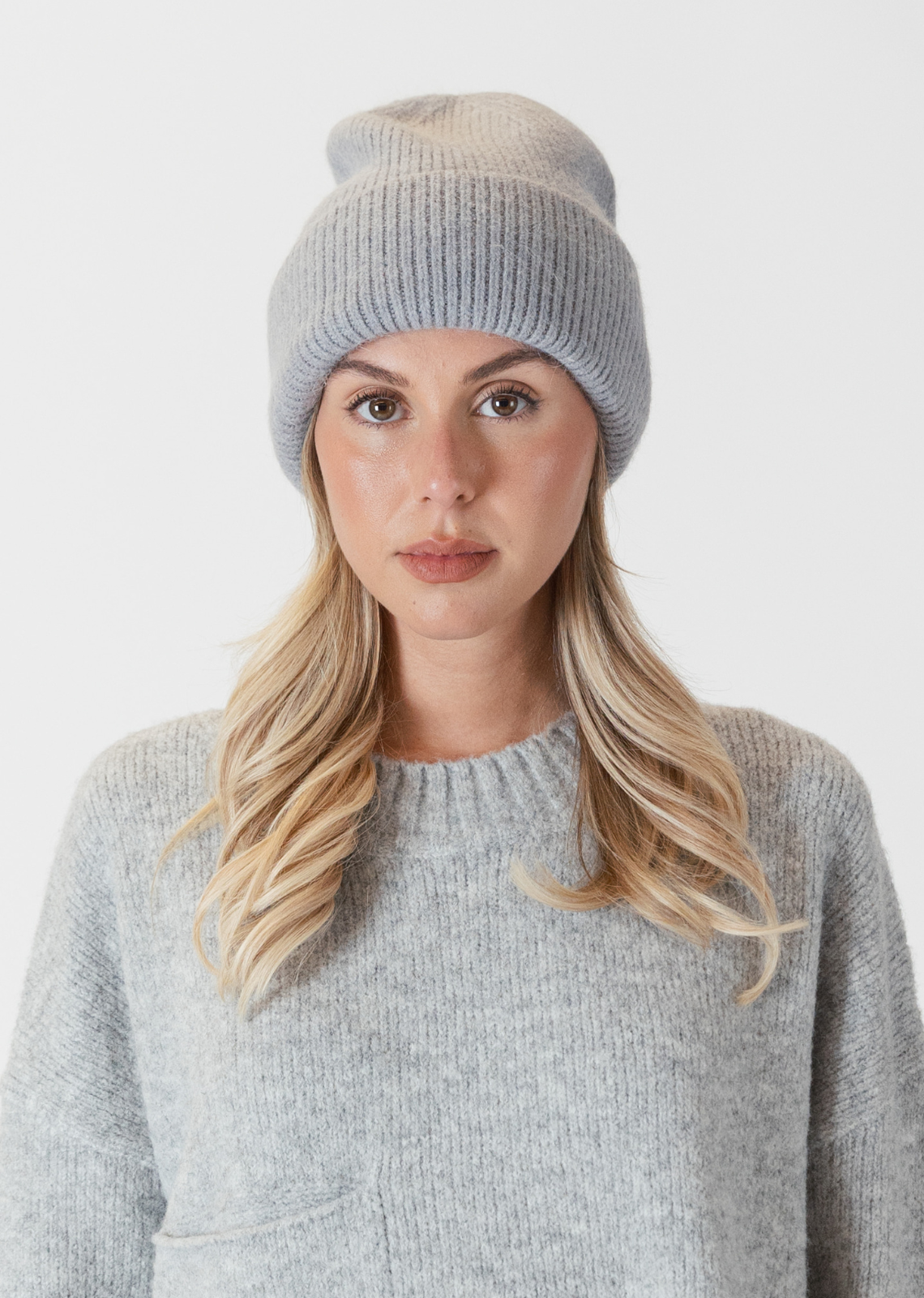 Lyla & Luxe Apres Ski Hat- Medium Grey. Introducing the Apres Ski Hat, your go-to accessory for embracing the après-ski vibe with flair and warmth. Made from high-quality materials, the Apres Ski Hat features a soft and insulating knit  construction that ensures optimal comfort in chilly weather conditions. Available in a range of stylish colors to suit your
personal taste, the Apres Ski Hat is the perfect finishing touch to any winter ensemble.