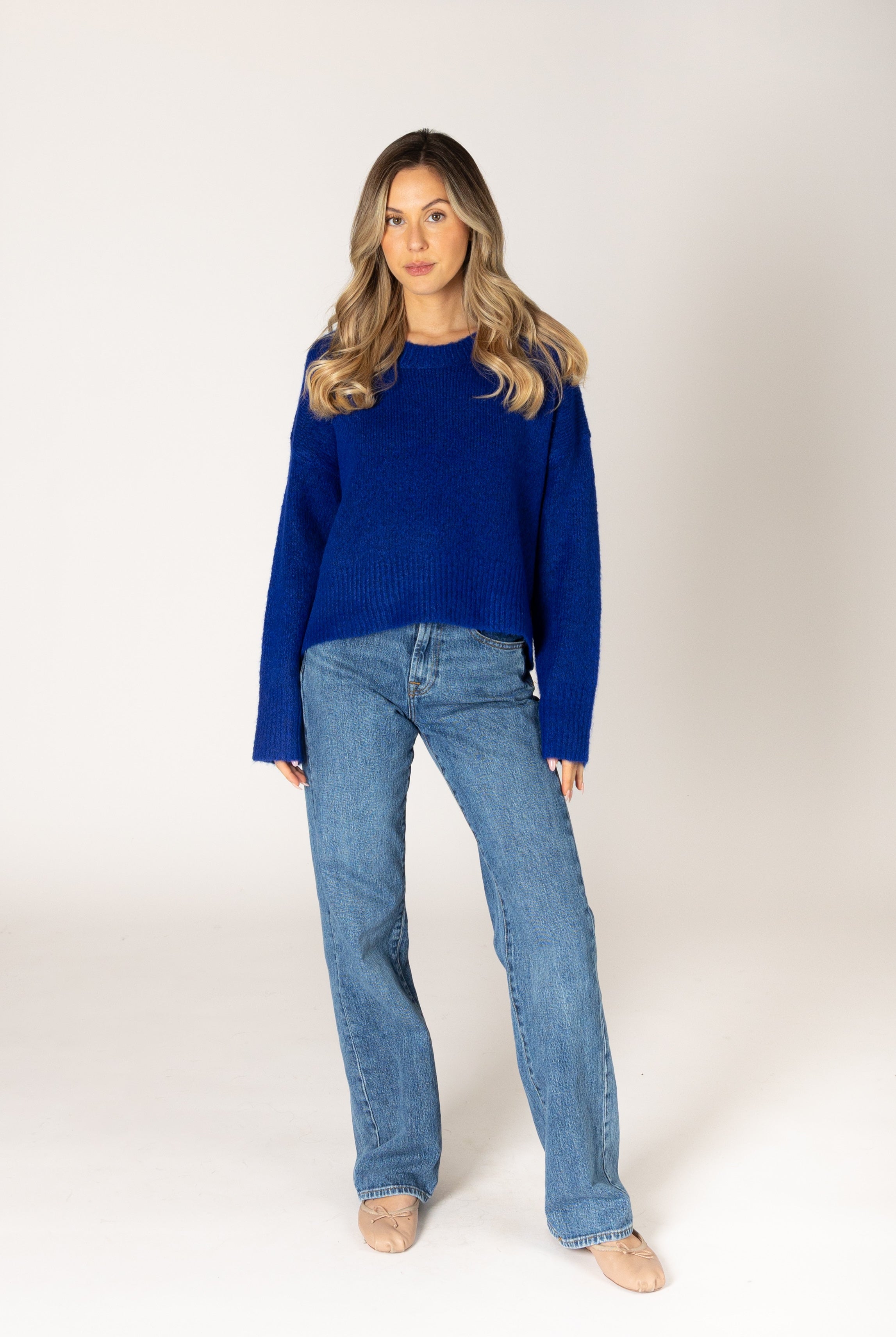 Classic crewneck sweater in a cobalt blue, featuring a simple silhouette with ribbed cuffs and hem.