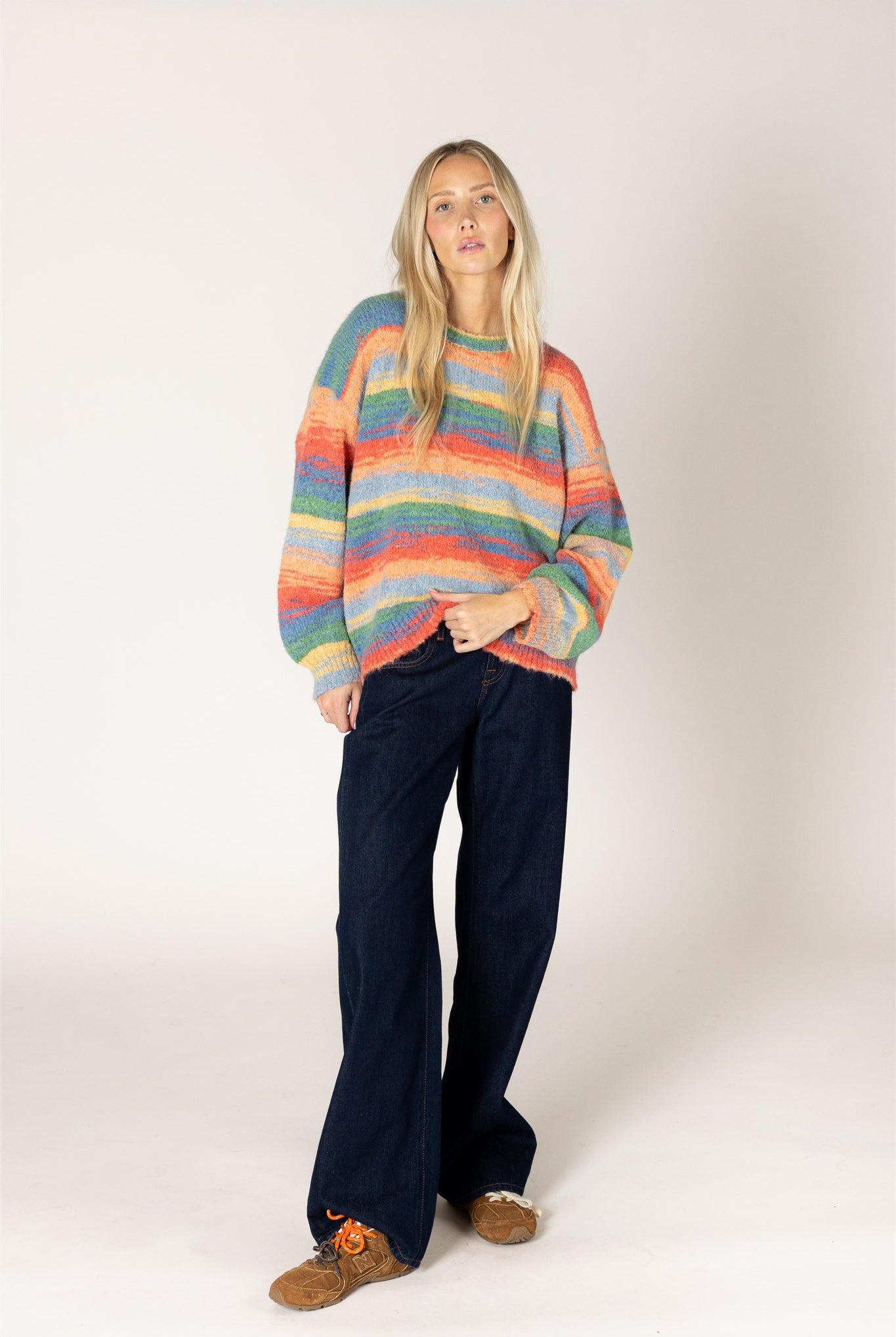 Multicolor striped fuzzy knit sweater featuring a relaxed fit, classic crew neckline, long sleeves, and ribbed cuffs and hem.