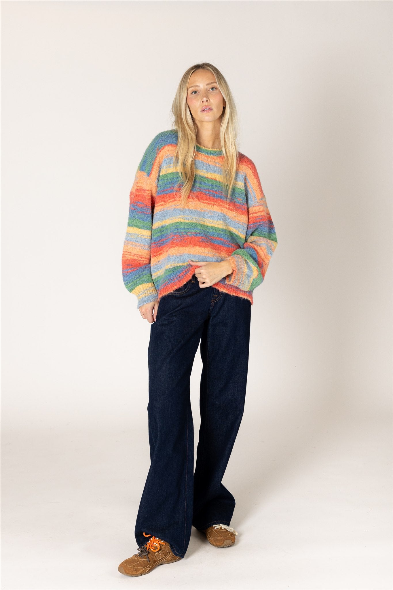 Multicolor striped fuzzy knit sweater featuring a relaxed fit, classic crew neckline, long sleeves, and ribbed cuffs and hem.