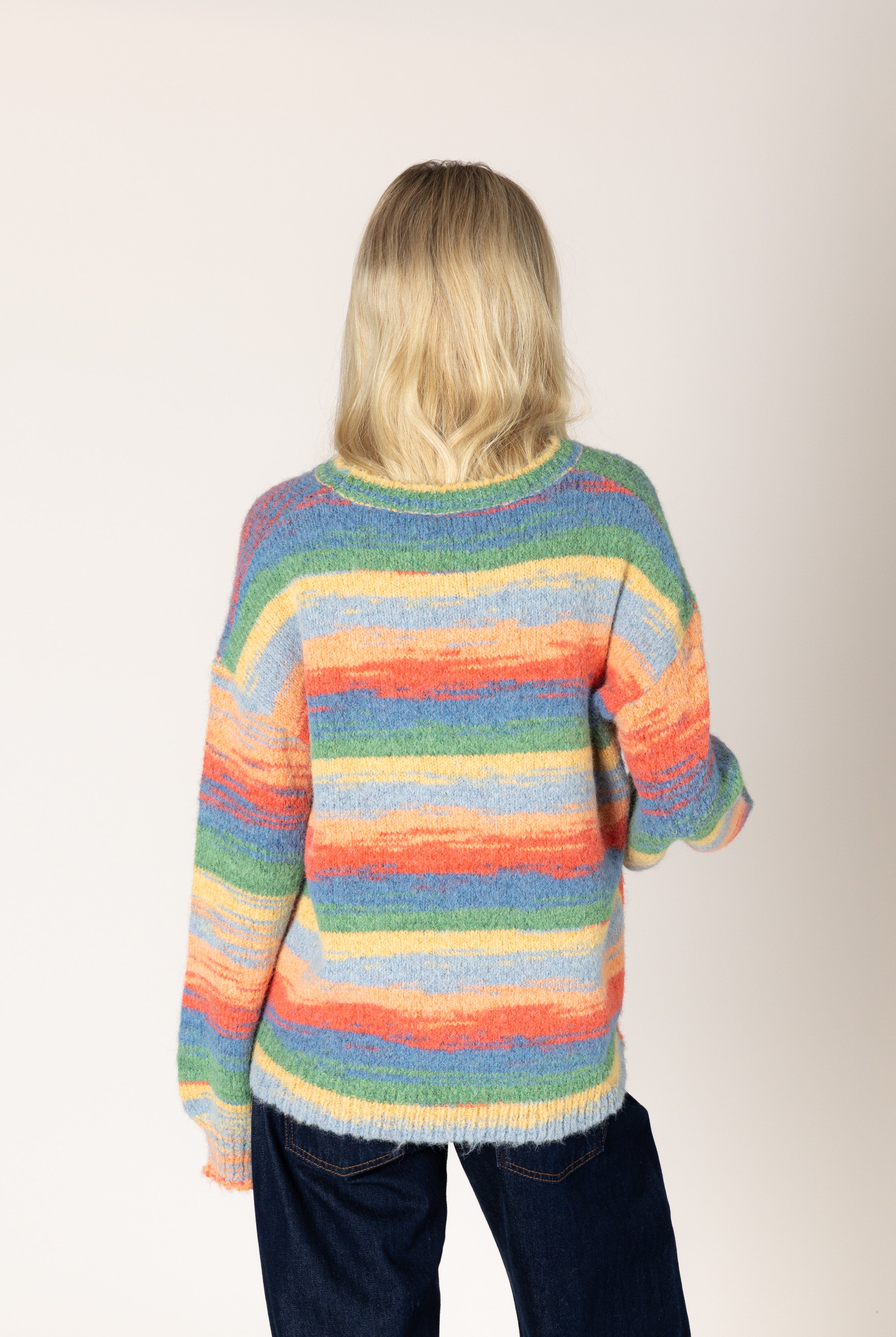 Multicolor striped fuzzy knit sweater featuring a relaxed fit, classic crew neckline, long sleeves, and ribbed cuffs and hem.