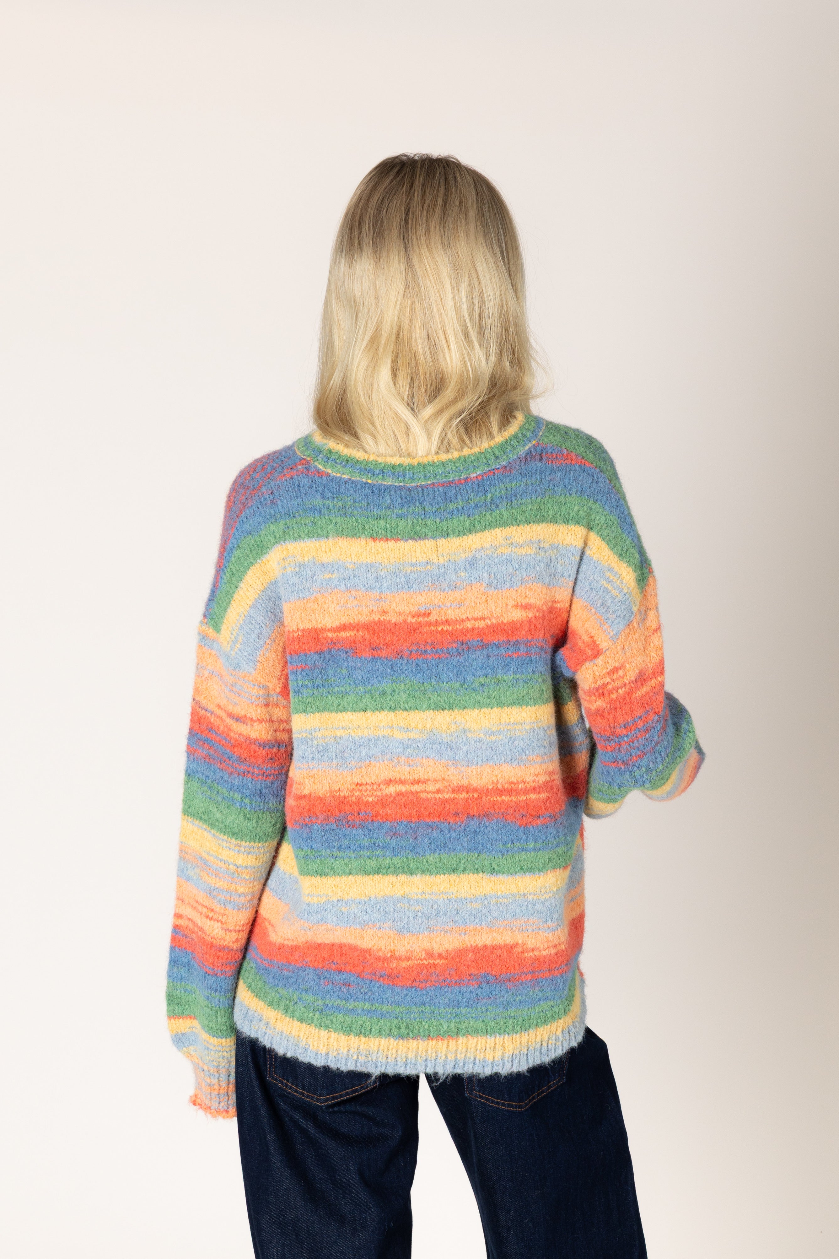 Multicolor striped fuzzy knit sweater featuring a relaxed fit, classic crew neckline, long sleeves, and ribbed cuffs and hem.