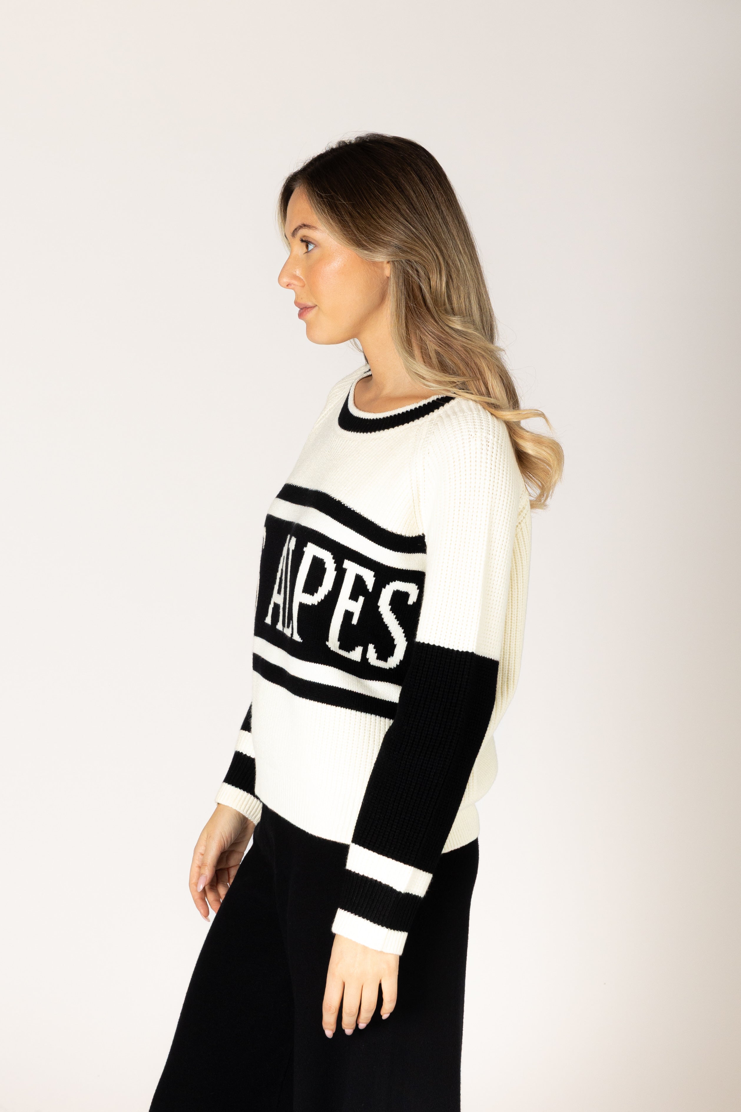 Black-and-white crewneck sweater featuring bold “LES ALPES” lettering across the front and a relaxed fit.