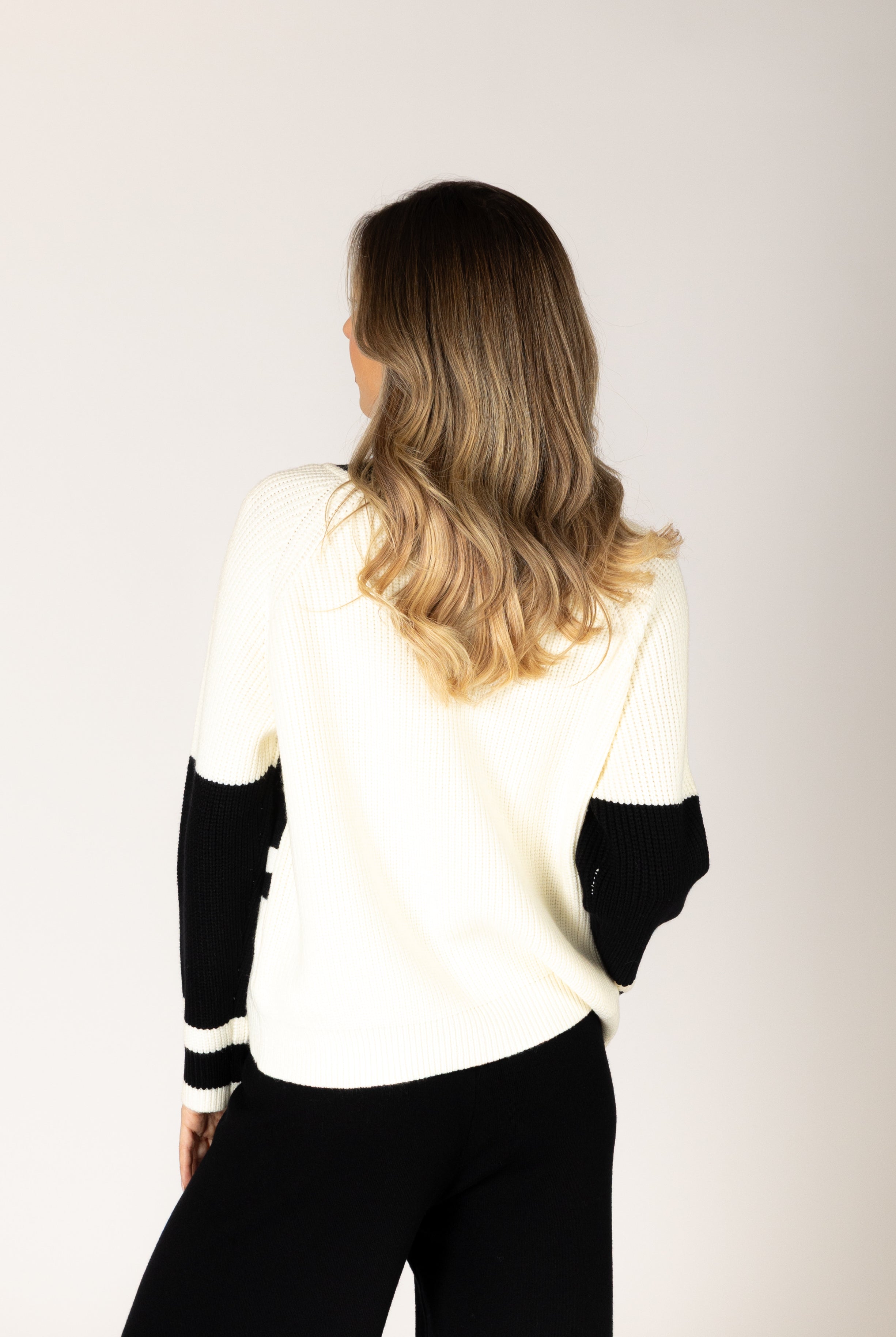 Black-and-white crewneck sweater featuring bold “LES ALPES” lettering across the front and a relaxed fit.