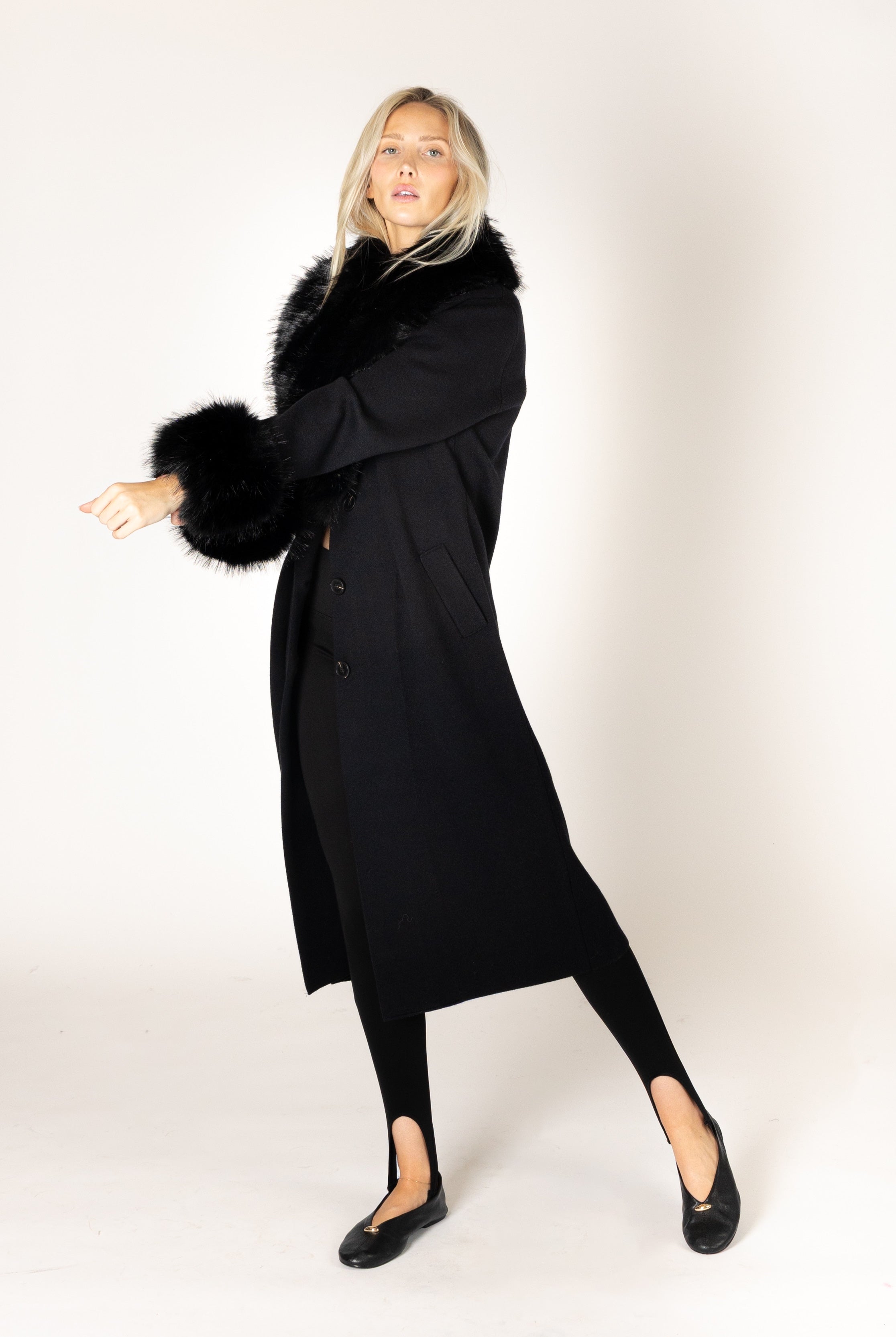 Make a statement this season with the elevated Vicki Fur Coat, designed with luxurious eco faux fur trim at the collar and cuffs for a touch of timeless glamour. Featuring a flattering longline silhouette, a classic notch collar, and a refined three-button closure, this sophisticated coat combines elegance with everyday wearability. Crafted to keep you warm while elevating any outfit, it's the perfect outerwear piece for both special occasions and everyday sophistication.
**Care:** Hand wash cold. Lay flat