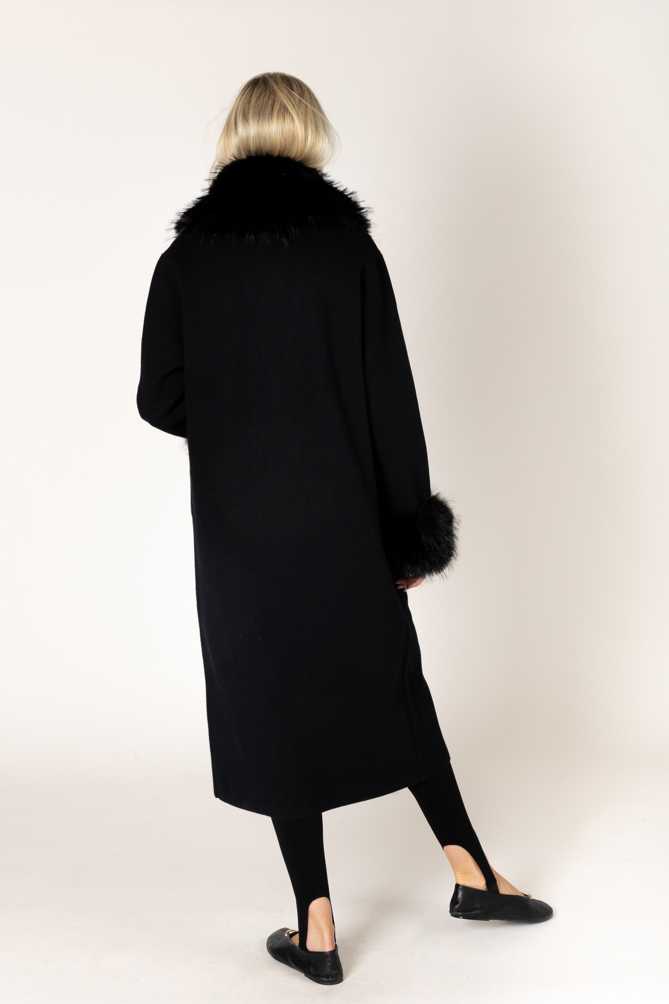 Make a statement this season with the elevated Vicki Fur Coat, designed with luxurious eco faux fur trim at the collar and cuffs for a touch of timeless glamour. Featuring a flattering longline silhouette, a classic notch collar, and a refined three-button closure, this sophisticated coat combines elegance with everyday wearability. Crafted to keep you warm while elevating any outfit, it's the perfect outerwear piece for both special occasions and everyday sophistication.
**Care:** Hand wash cold. Lay flat