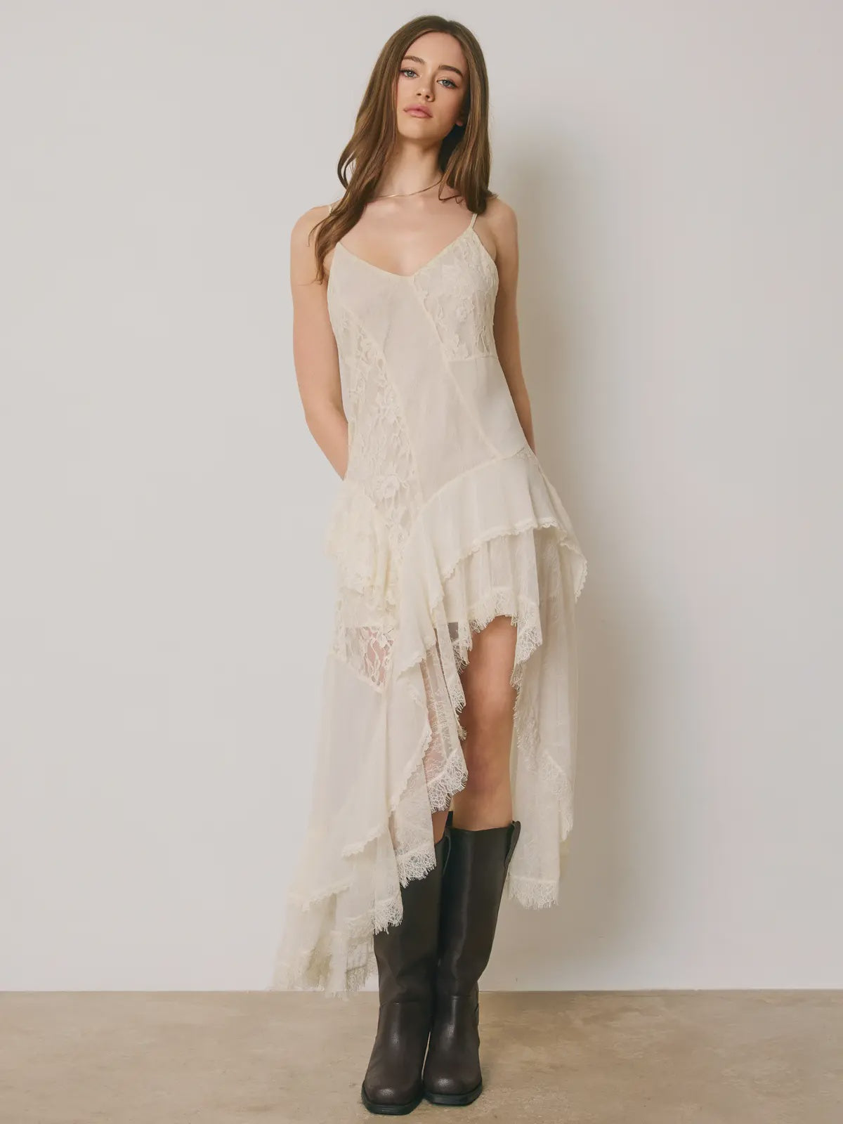 Marielle Lace Tiered Midi Dress featuring delicate floral lace, mixed lace panel detailing, cascading tiered ruffles, and an asymmetrical high-low hemline. Designed with a flattering V-neckline, adjustable spaghetti straps, a scoop back, and a romantic, flowy silhouette.