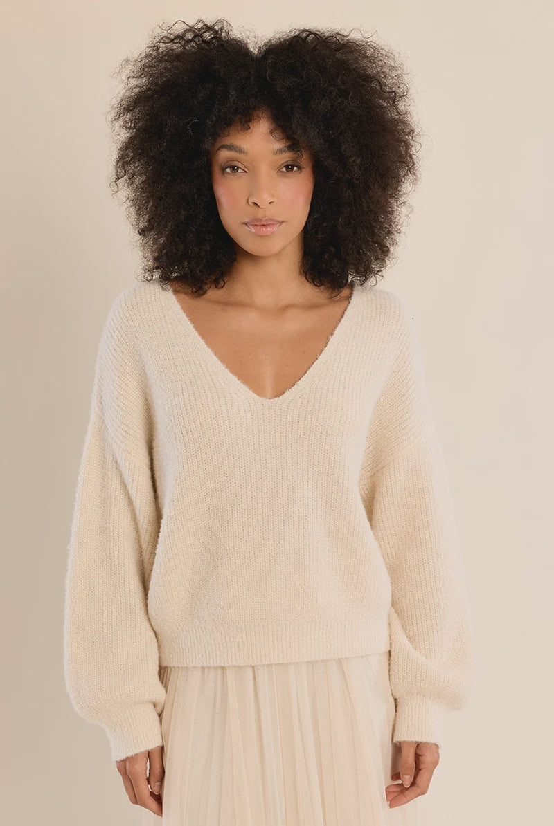 Long-sleeve V-neck sweater featuring a straight fit and delicate lace bow detail at the back.