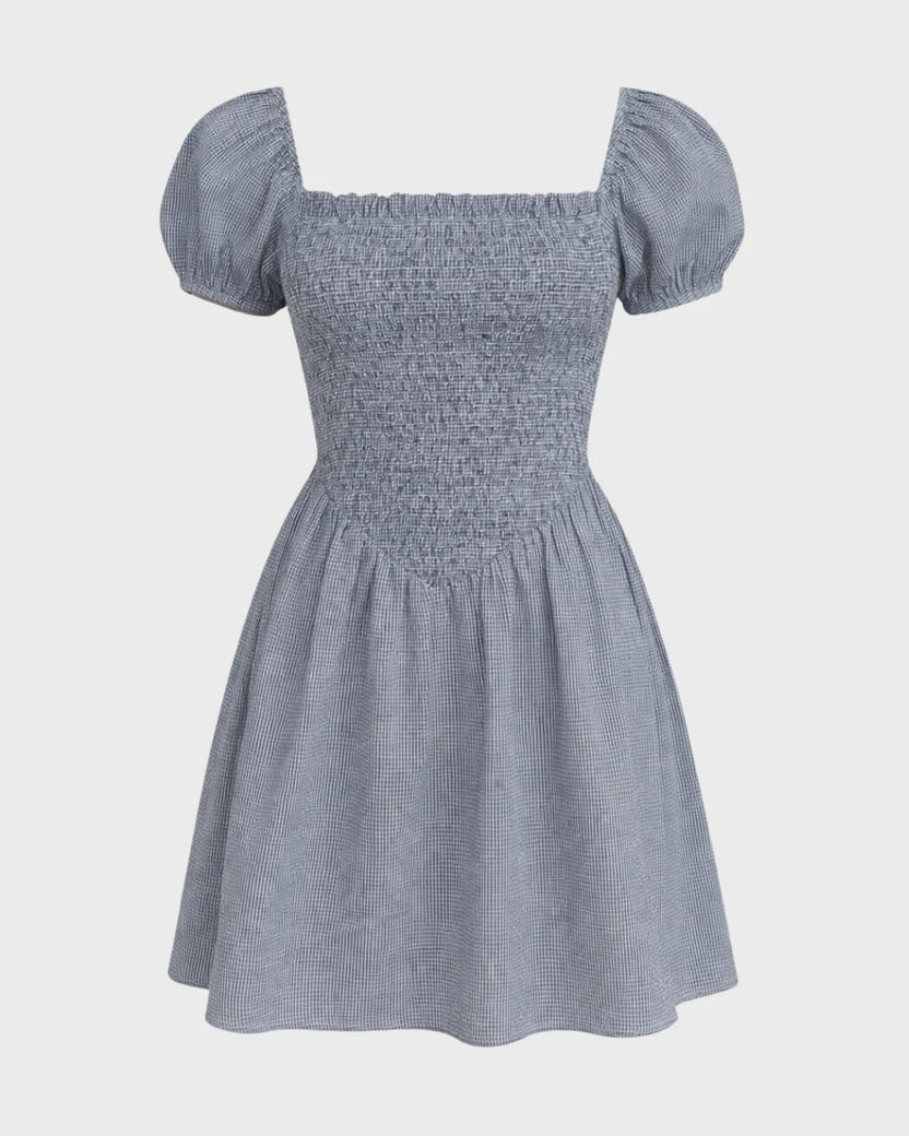 Blue checkered dress with puff sleeves on a light gray background