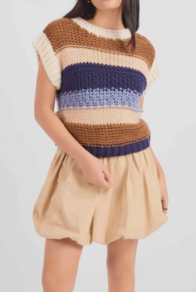 Sleeveless chunky knit top featuring a warm multi-colour stripe pattern, cozy textured finish, and relaxed, slightly boxy fit.