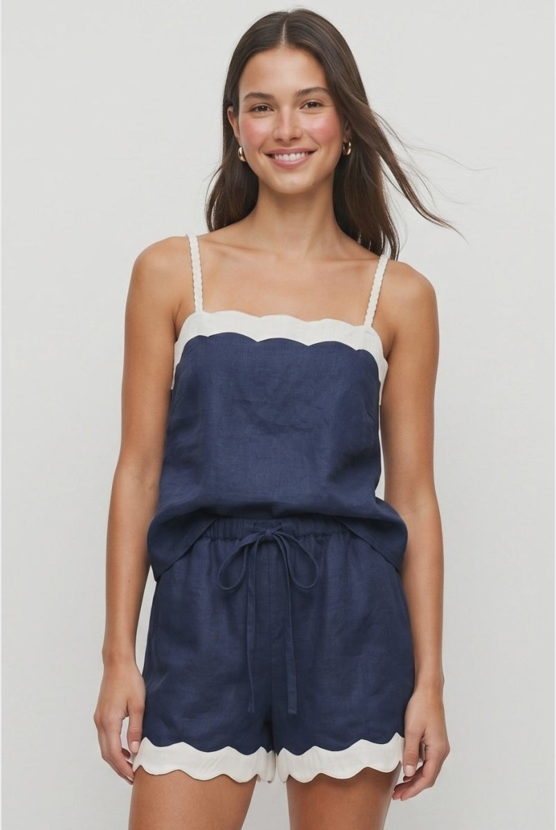 Navy linen-blend tank top featuring a cream scalloped neckline, braided adjustable spaghetti straps, a relaxed fit, and a lightweight woven finish. Designed with a back keyhole and button closure for an elegant summer look.