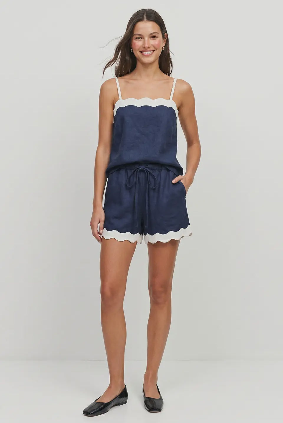 Navy linen-blend pull-on shorts featuring scalloped hems, side pockets, and a self-fabric drawstring waistband
