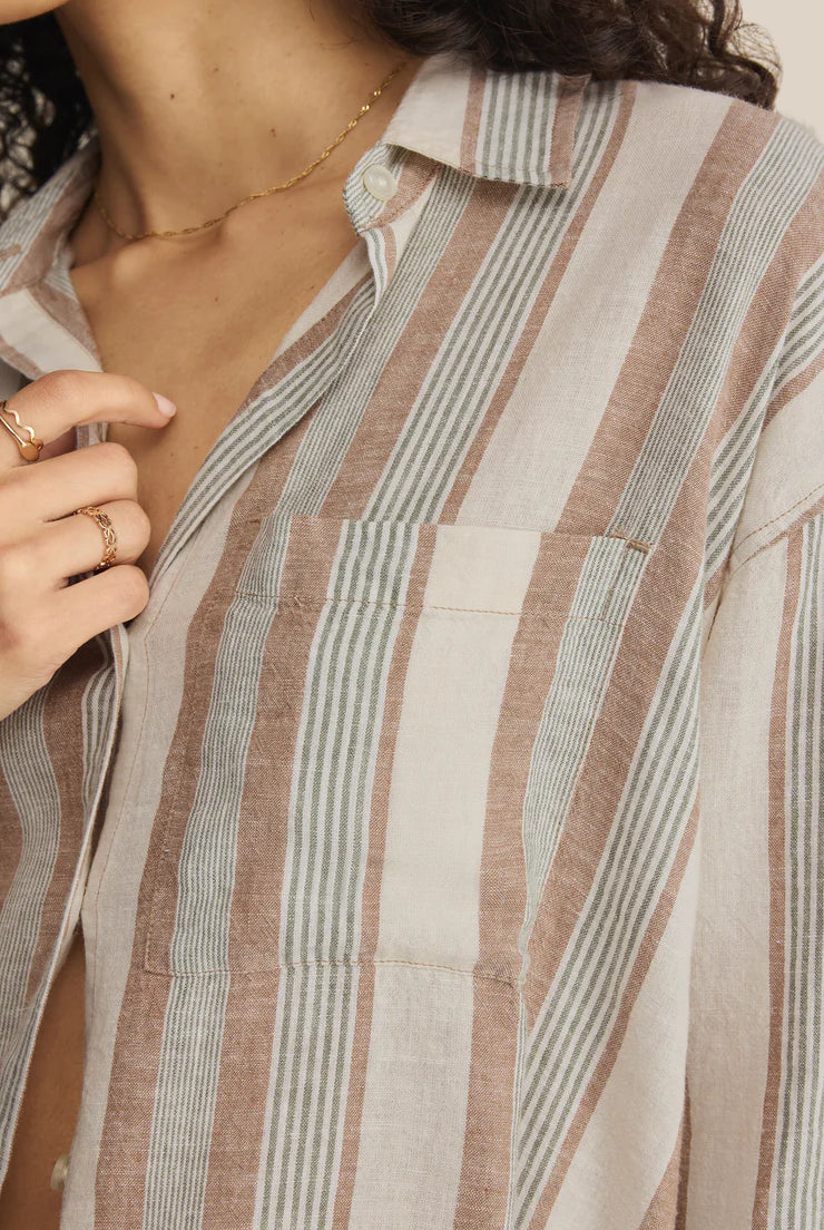 Close-up of a person wearing a striped shirt with a neutral background. Fashion Clothing Store for Women in Hamilton and Burlington Ontario!