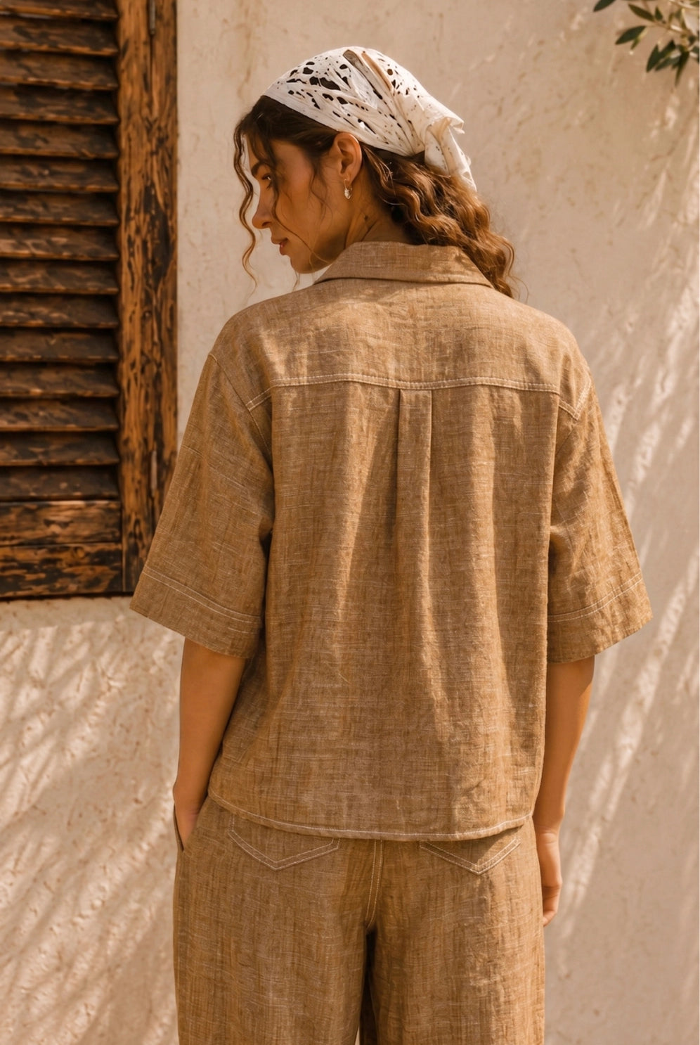 Women's brown linen blend camp shirt with a relaxed boxy fit, button-front closure, camp collar, oversized patch pockets, and contrast stitching.
