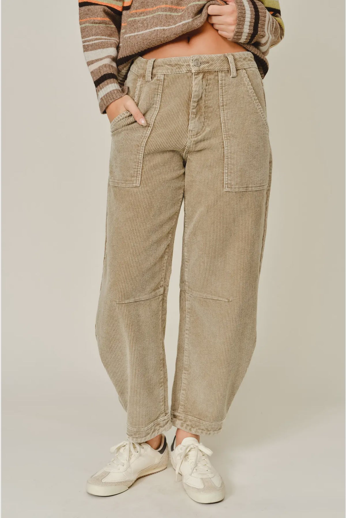 Thea Corduroy Barrel Pants in Taupe featuring a high-rise waist, relaxed barrel-leg silhouette, soft textured corduroy fabric, oversized front patch pockets, subtle seam detailing, and tapered ankle-length hems.
