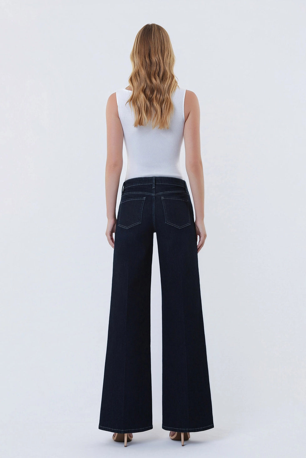 Dark wash wide-leg jeans featuring a mid-rise waist, trouser-inspired front crease, classic five-pocket design, finished hem, and full-length silhouette.