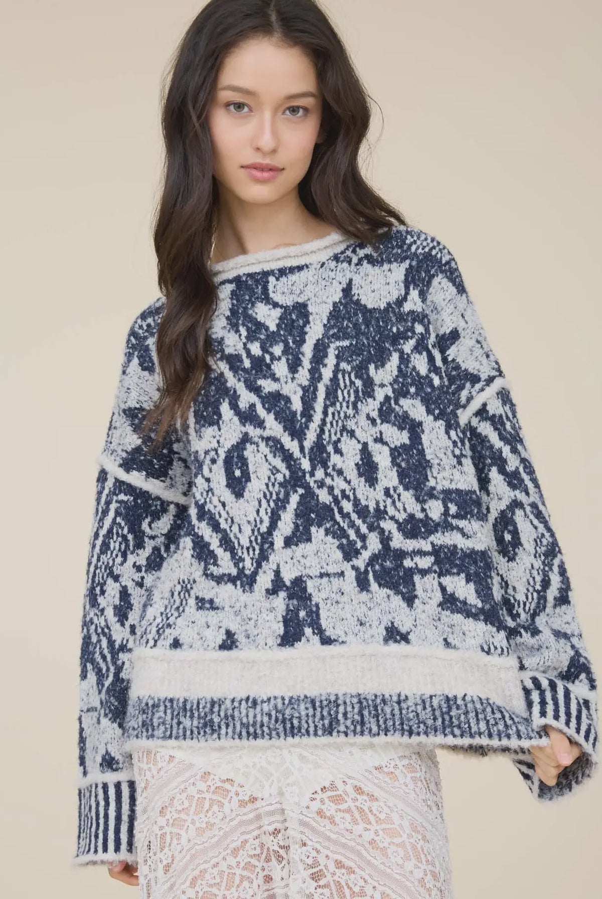 Women’s navy and cream printed knit pullover featuring an all-over pattern, relaxed fit, long sleeves, and contrast ribbed trim.