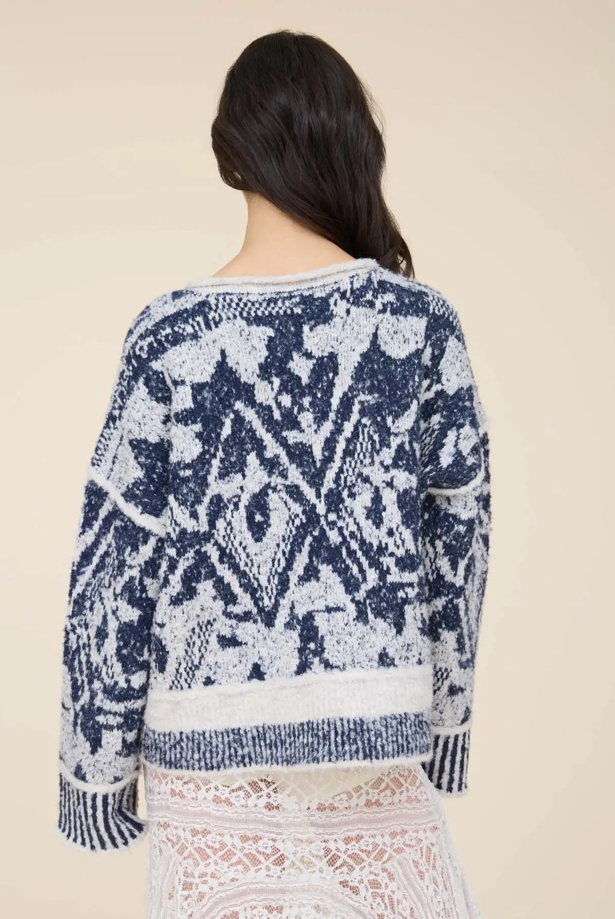 Women’s navy and cream printed knit pullover featuring an all-over pattern, relaxed fit, long sleeves, and contrast ribbed trim.