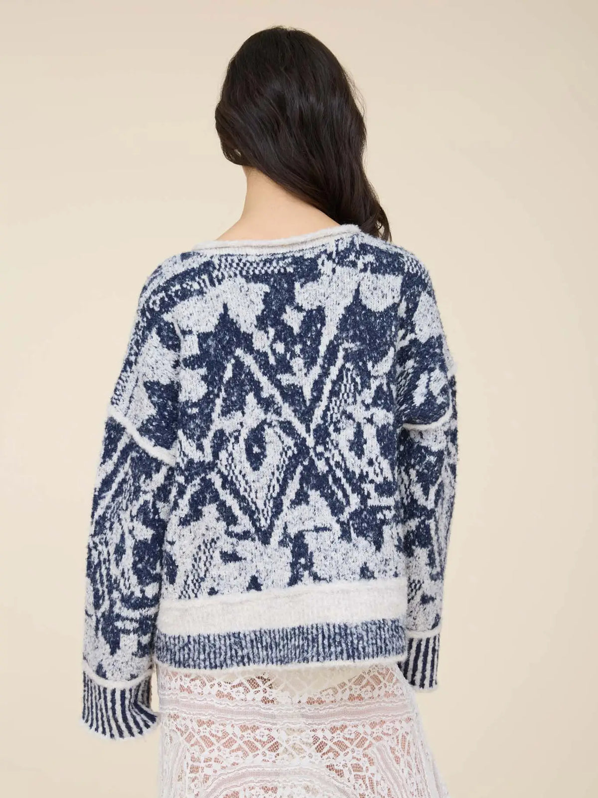Women’s navy and cream printed knit pullover featuring an all-over pattern, relaxed fit, long sleeves, and contrast ribbed trim.