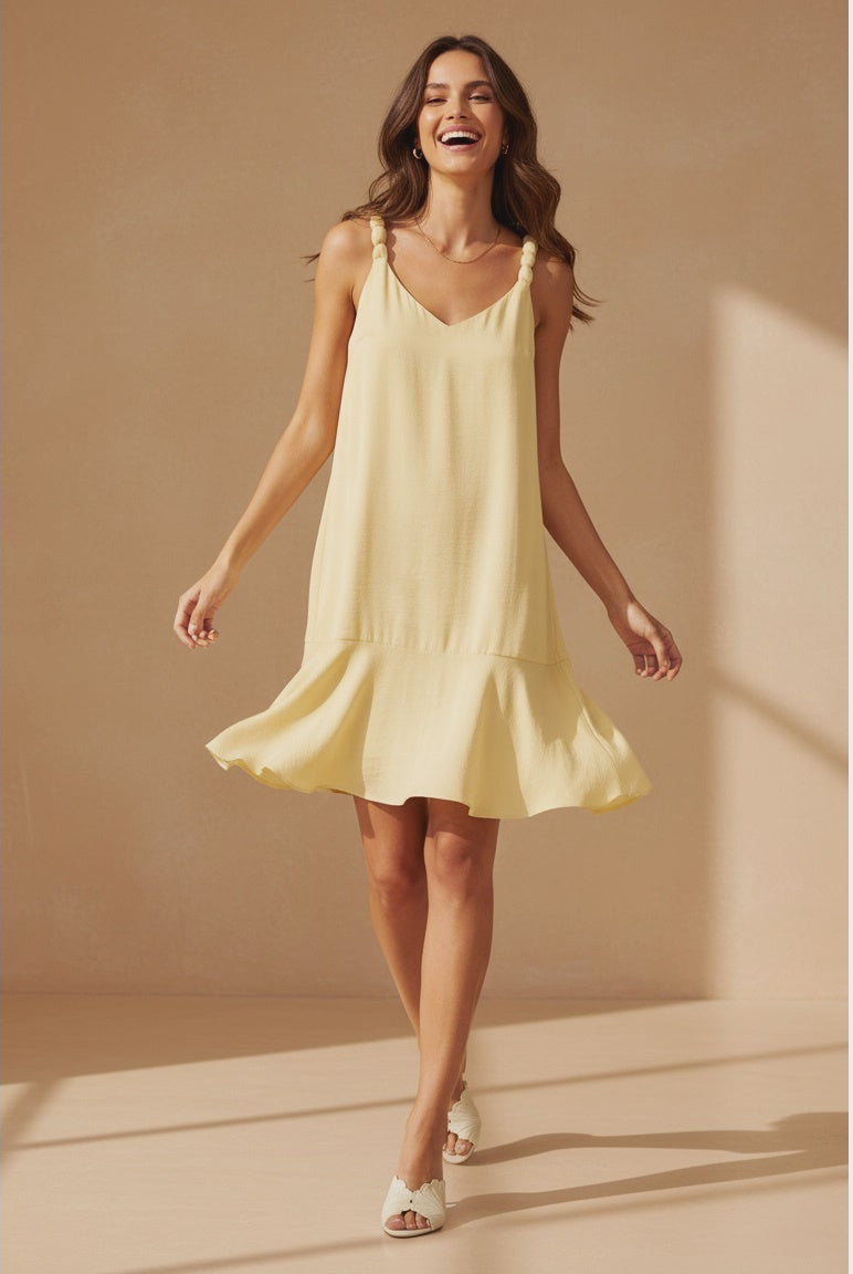 Pale banana sleeveless mini dress featuring a V-neckline, delicate ball-detail shoulder straps, a relaxed A-line silhouette, and a flutter hem