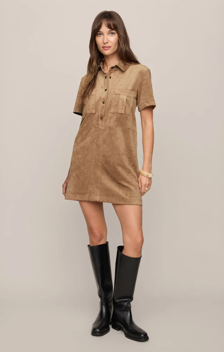 Faux suede mini shift dress featuring a collared neckline, short sleeves, front snap-button closures, chest and front patch pockets, and a relaxed fit.