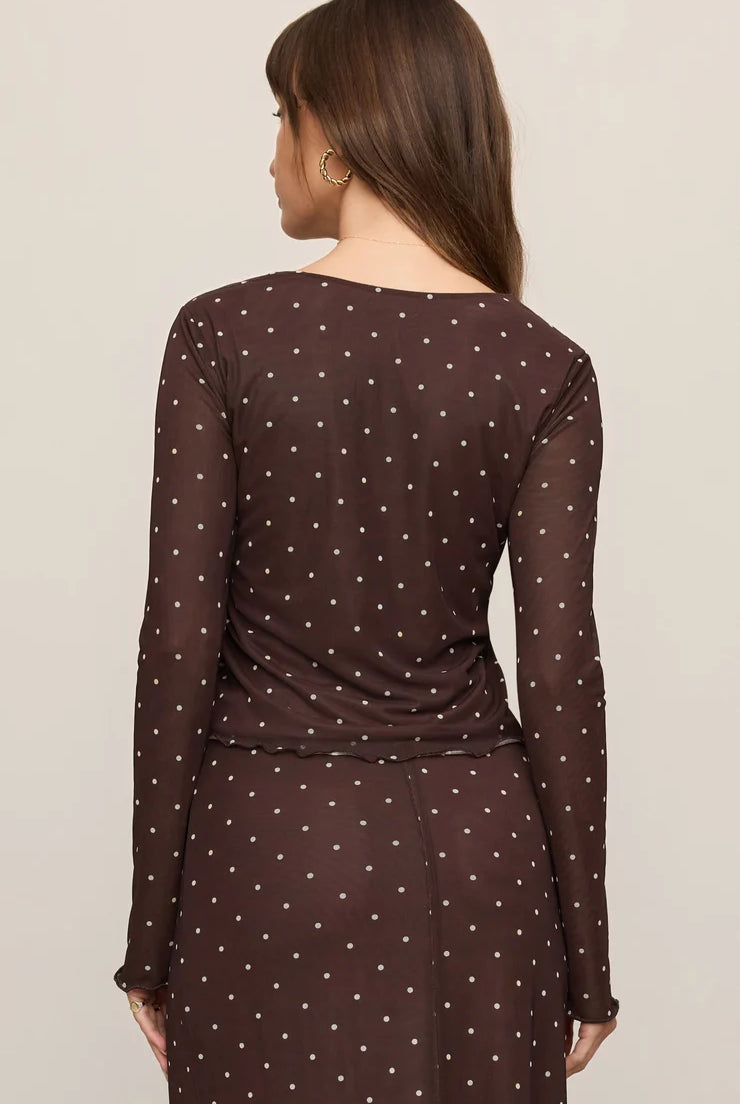 Brown mesh long-sleeve top with white polka dots, featuring a V-neckline, delicate front ties, and a slightly sheer fitted design.