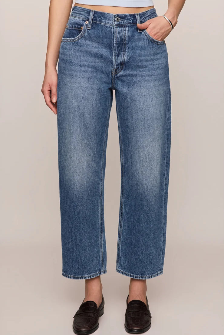 Vintage-wash blue mid-rise jeans featuring a relaxed bowed-leg silhouette, ankle-length hem, and classic five-pocket styling.