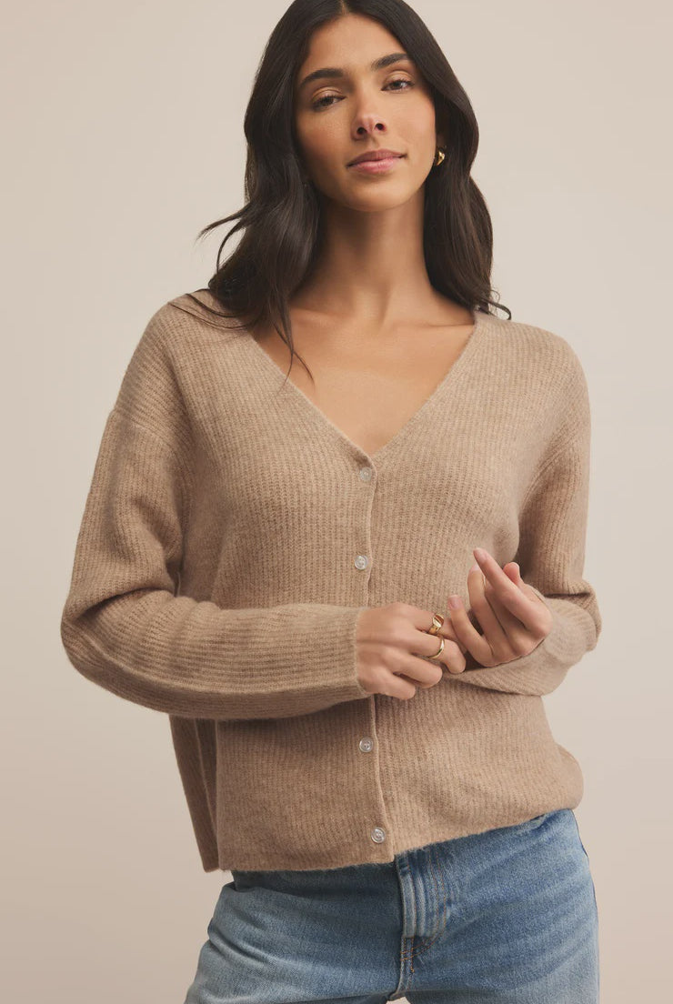 A girl wearing a V Neck Beighe cardigan with jeans