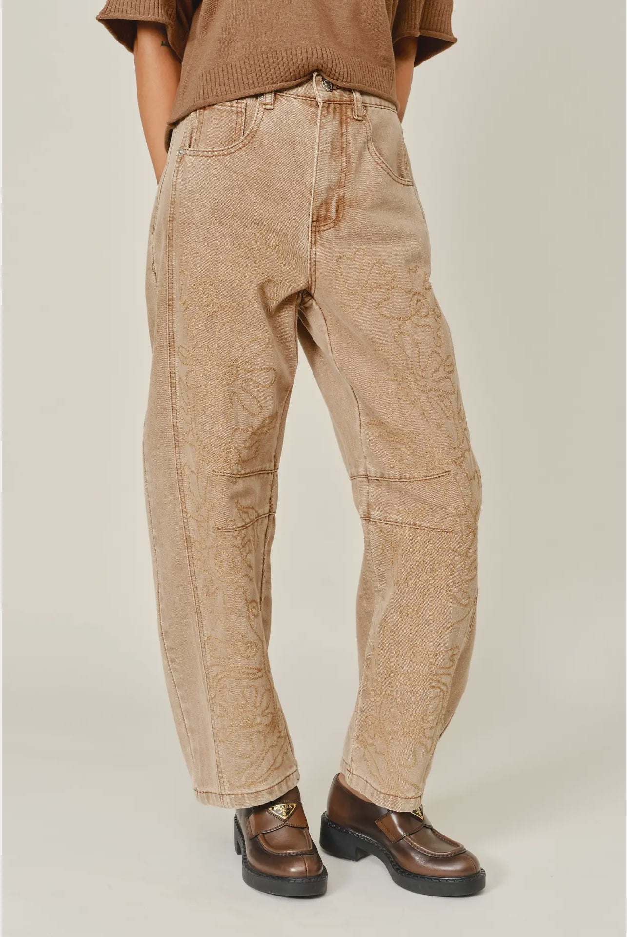 The Ophelia Embroidered Barrel Jeans in rust, featuring tonal floral embroidery, a relaxed barrel-leg silhouette, and a cropped ankle-length fit.