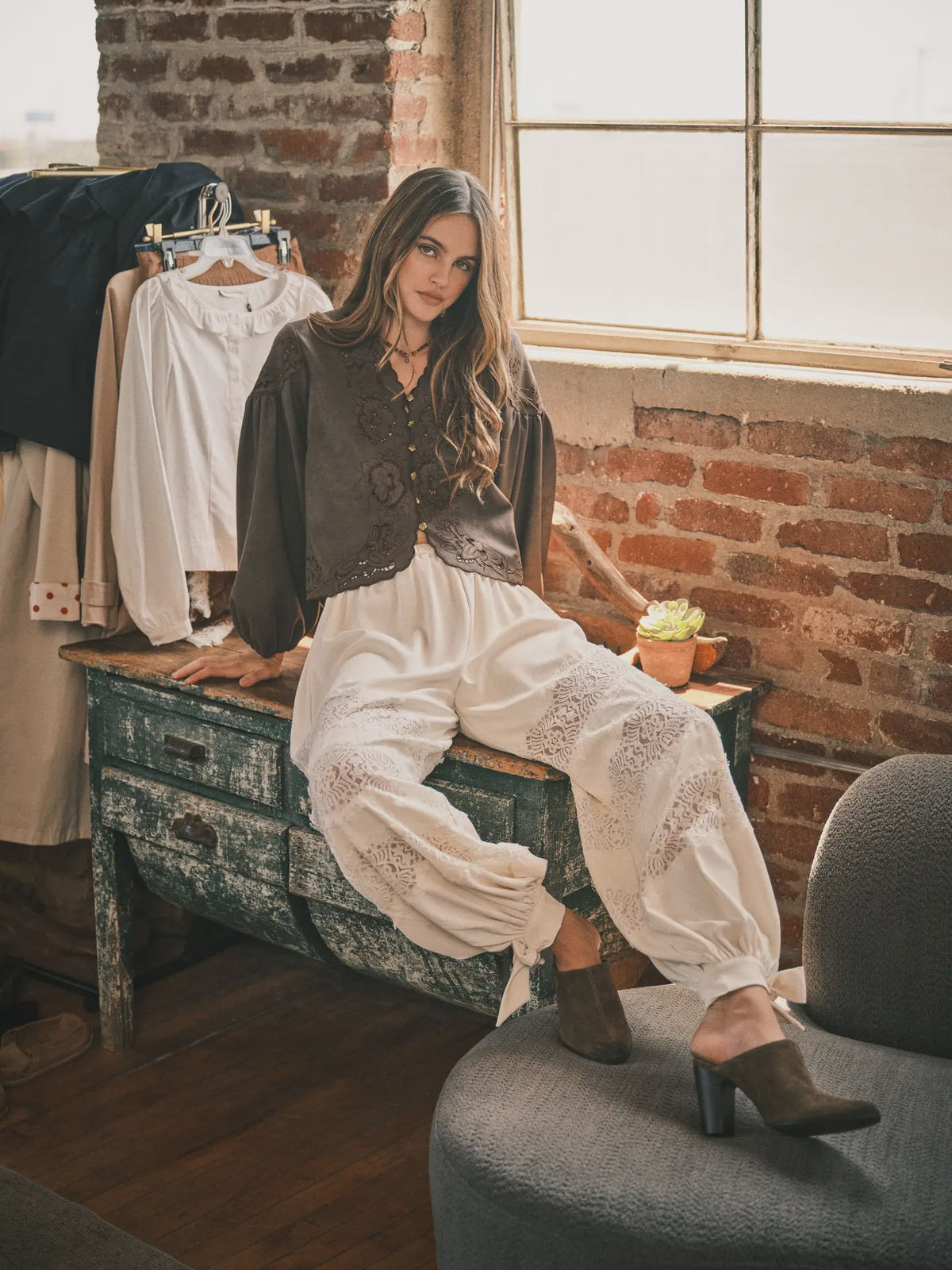 Women’s brown boho blouse featuring tonal floral embroidery, scalloped V-neckline, button-front closure, and relaxed long balloon sleeves.