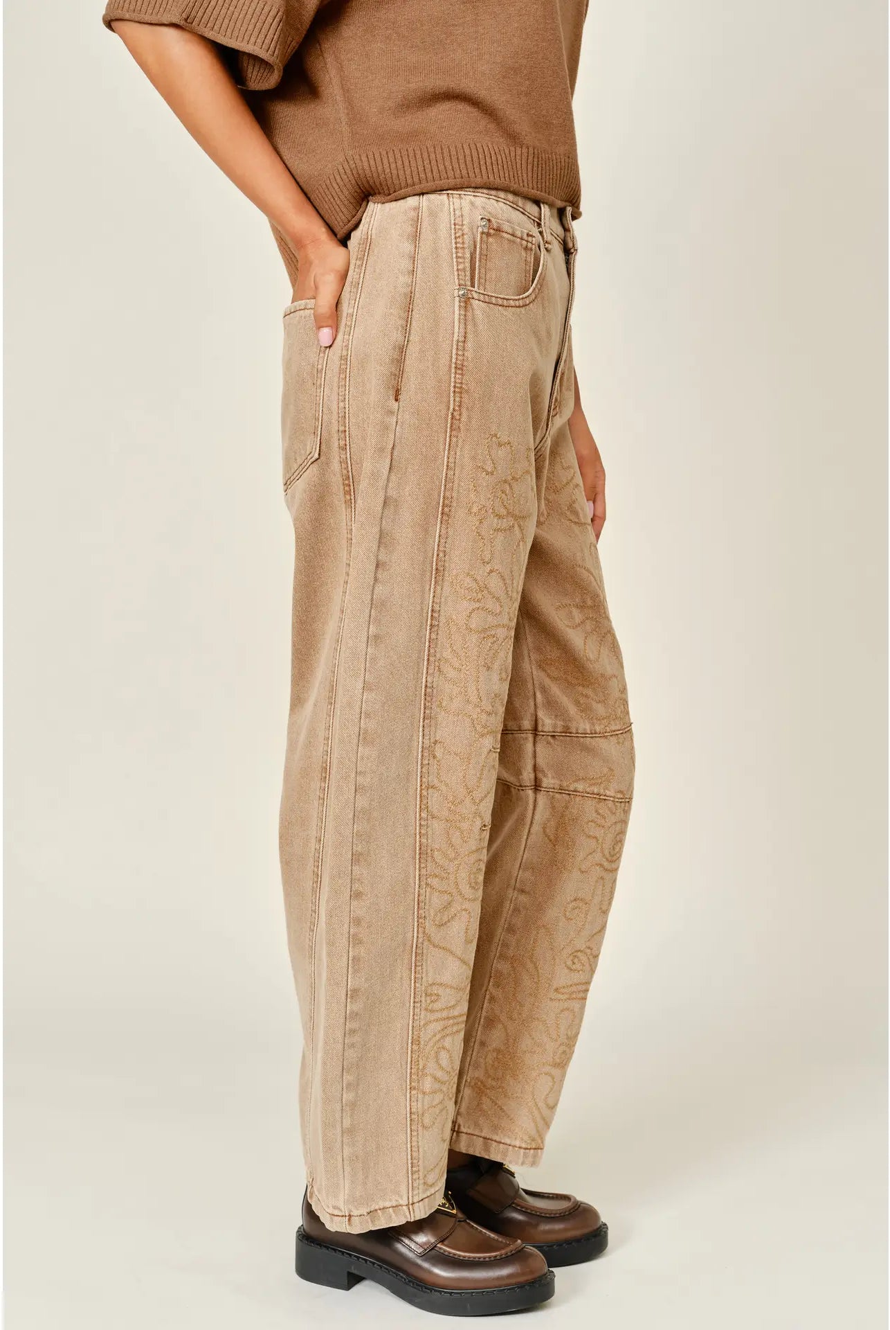 The Ophelia Embroidered Barrel Jeans in rust, featuring tonal floral embroidery, a relaxed barrel-leg silhouette, and a cropped ankle-length fit.